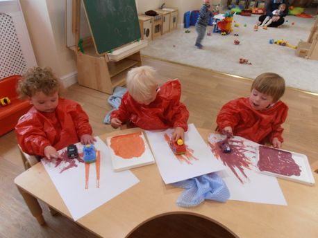 hook-a-gate nursery children playing with paint